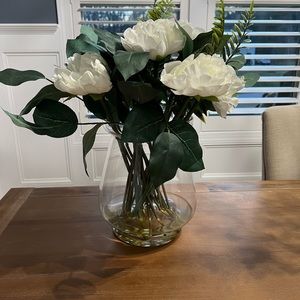 Artificial floral arrangement in a glass vase.
